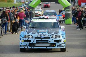 Lia Block / Rhianon Gelsomino Ford Escort Cosworth RS leaves the ceremonial start.