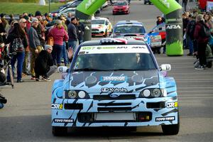 Lia Block / Rhianon Gelsomino Ford Escort Cosworth RS leaves the ceremonial start.