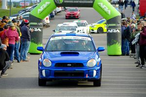 Jimmy Pelizzari / Kate Stevens Subaru WRX leaves the ceremonial start.