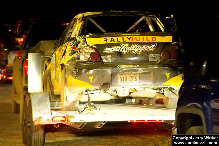 After rolling, a heavily damaged Colin Schulz / Jake Carlson Subaru WRX STi leaves Sidnaw service.