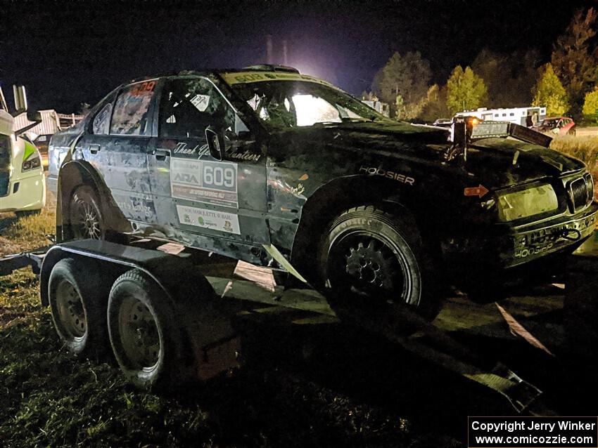 Keenan Phillips / Salina Melotti BMW 328i at Sidnaw service after rolling hard on day one.