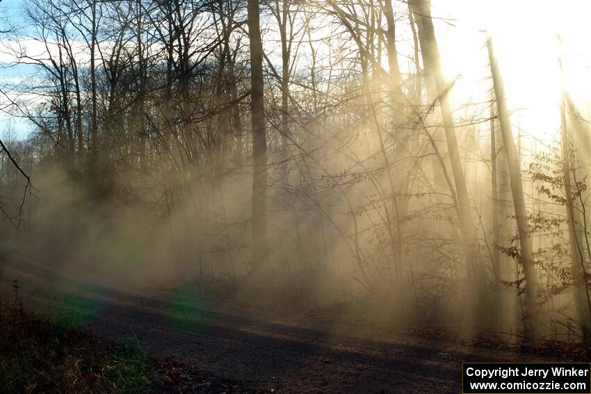 Dust hangs in the air between cars on SS2.