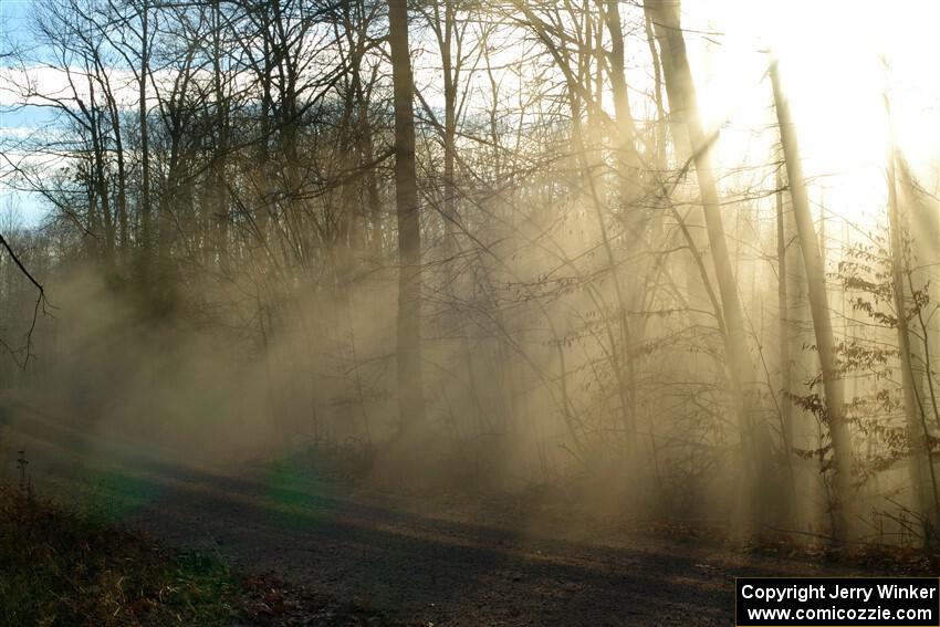 Dust hangs in the air between cars on SS2.