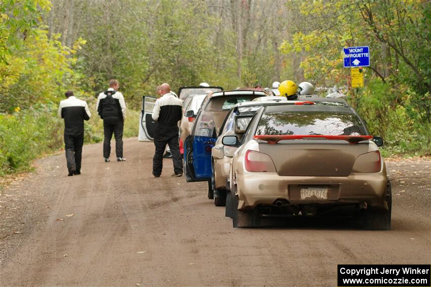 The lineup to the start of SS16, Mount Marquette, with Jason Cook / Maggie Tu Subaru WRX at the end.