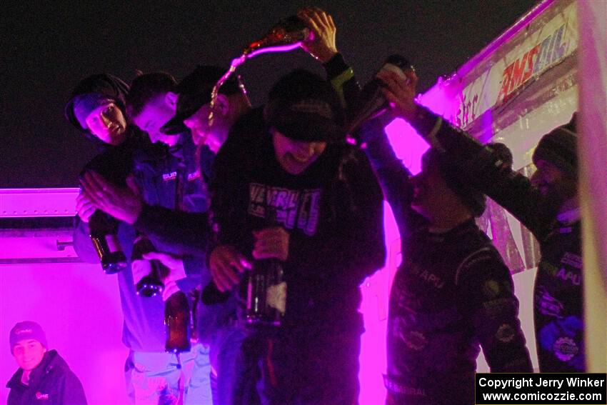 K.J. Miller is doused in champagne on the winners' podium.