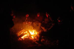 Marshals and workers keep warm by a campfire before SS15, Camp 30-East Branch II.