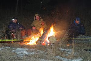 Marshals and workers keep warm by a campfire before SS15, Camp 30-East Branch II.