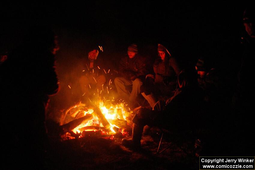 Marshals and workers keep warm by a campfire before SS15, Camp 30-East Branch II.