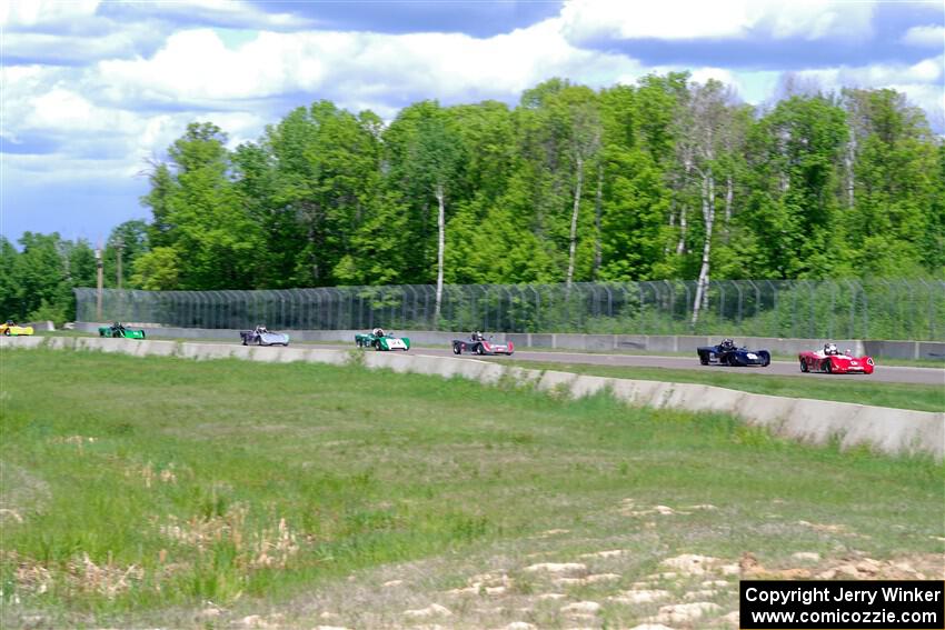 The Spec Racer Ford 3 field comes through turn 2 on the first lap.
