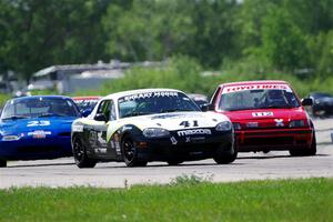 Samantha Silver's Spec Miata Mazda Miata passes Ken Sonderup's ITC Honda Civic