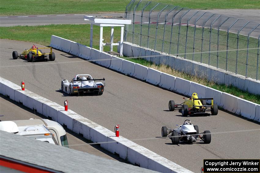 The Formula and Sports Racer group leaves pit lane on the pace lap.