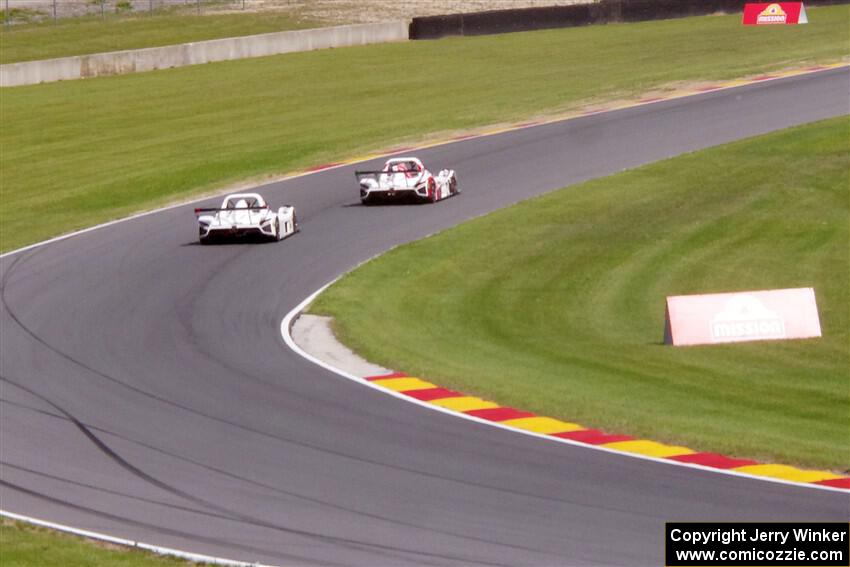 Two Radical SR3 XXRs exit the carousel.
