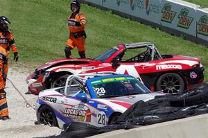 Robert Stout's and Ara Malkhassian's Mazda MX-5 Cups crash out at turn 7.
