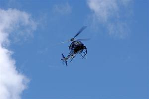 An helicopter flies high above turn one during the Porsche GT3 Cup race.