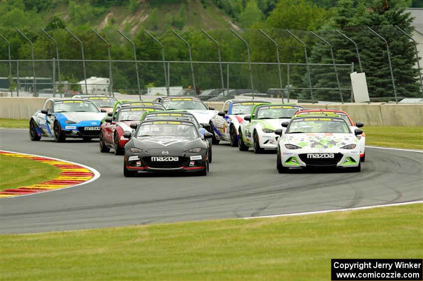 The Mazda MX-5 Cup field heads through turn 14 on the pace lap - John Dean, II and Nathanial Sparks front row.