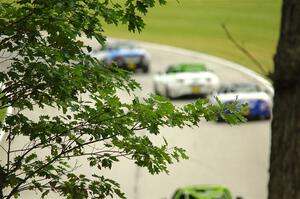 Three unknown Mazda MX-5 Cups head uphill through turn 13.