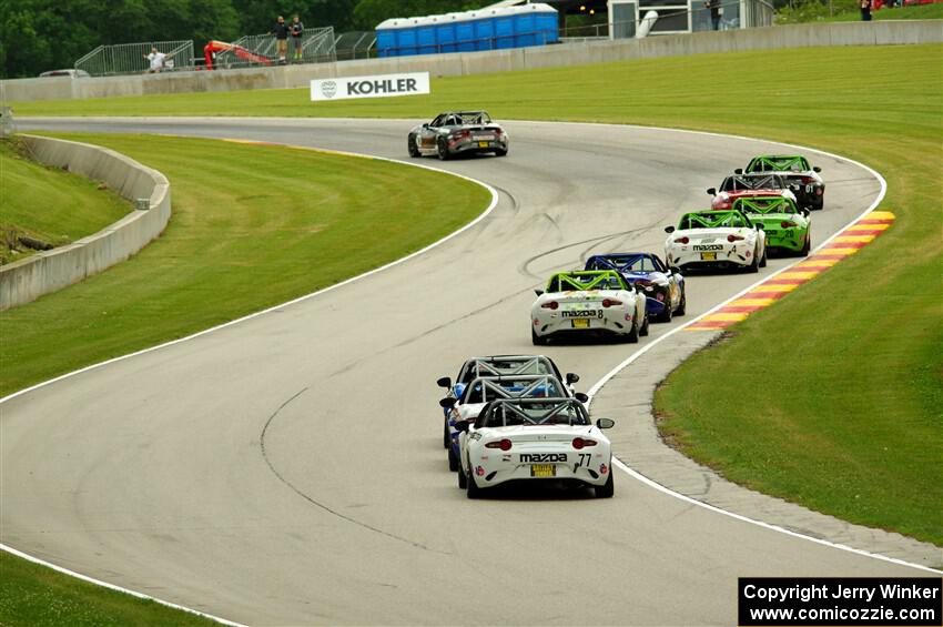 Mazda MX-5 Cup cars head through Thunder Valley.