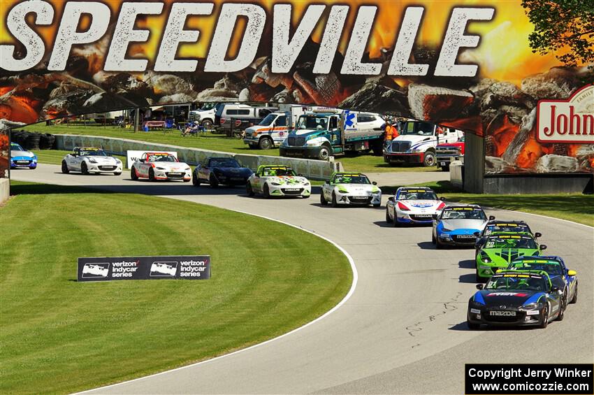 Mazda MX-5 Cup cars in the carousel on lap 2.