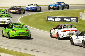 Hernan Palermo's, Thomas Bernacki's and Luke Oxner's Mazda MX-5 Cups at the tail of the lead pack.