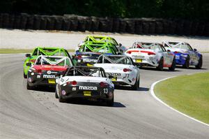 Luke Oxner's and Robert Noaker's Mazda MX-5 Cups at the tail of the lead pack.