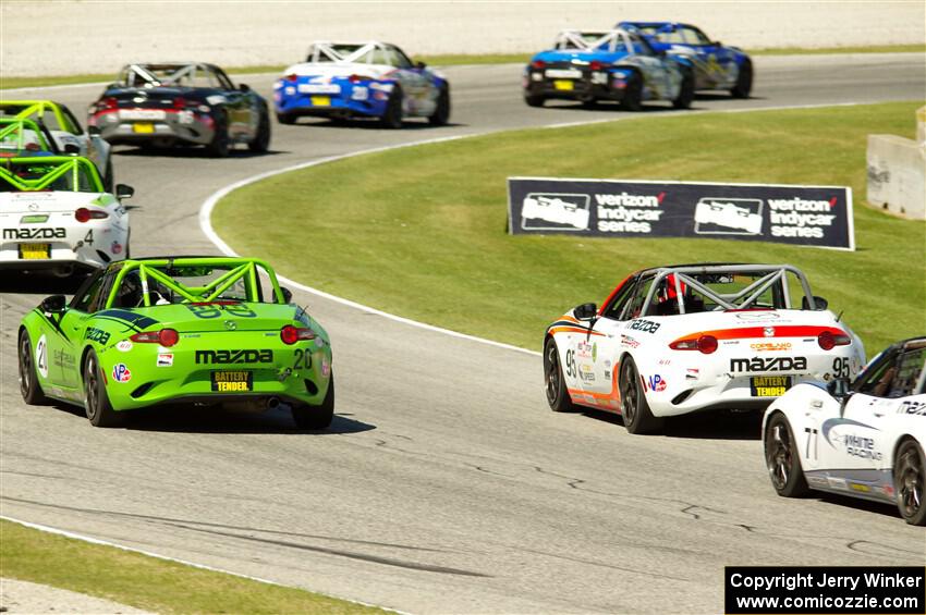 Hernan Palermo's, Thomas Bernacki's and Luke Oxner's Mazda MX-5 Cups at the tail of the lead pack.