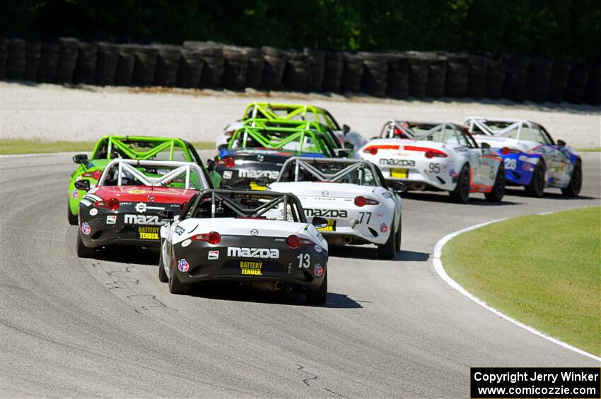 Luke Oxner's and Robert Noaker's Mazda MX-5 Cups at the tail of the lead pack.