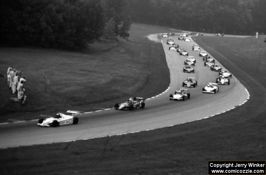 The field comes through turns six and seven on the pace lap.