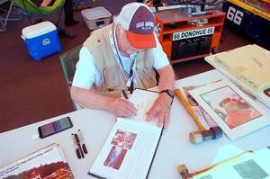 Photographer/Racing Historian Ron Nelson sells his book at the Vintage Indy display.