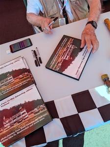 Photographer/Racing Historian Ron Nelson sells his book at the Vintage Indy display.