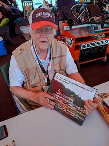Photographer/Racing Historian Ron Nelson sells his book at the Vintage Indy display.