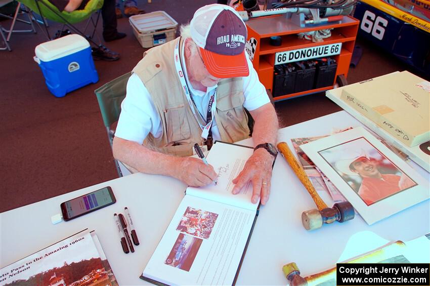 Photographer/Racing Historian Ron Nelson sells his book at the Vintage Indy display.