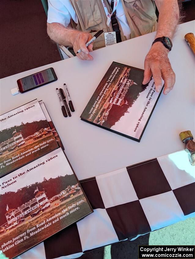 Photographer/Racing Historian Ron Nelson sells his book at the Vintage Indy display.