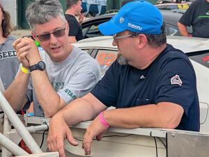 Jim Cox and Scott Parrott converse at parc expose at Soo Pass Ranch.