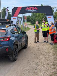 The 'Safety Delegate' car, a Subaru Crosstrek, pulls into the start of SS1, Soo Pass I.