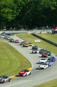 The field comes into the Hurry Downs on lap 1 of race 1.