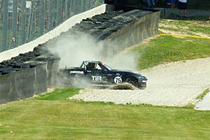 Parker Kligerman's Mazda MX-5 Cup backs it into the tires at turn 6.