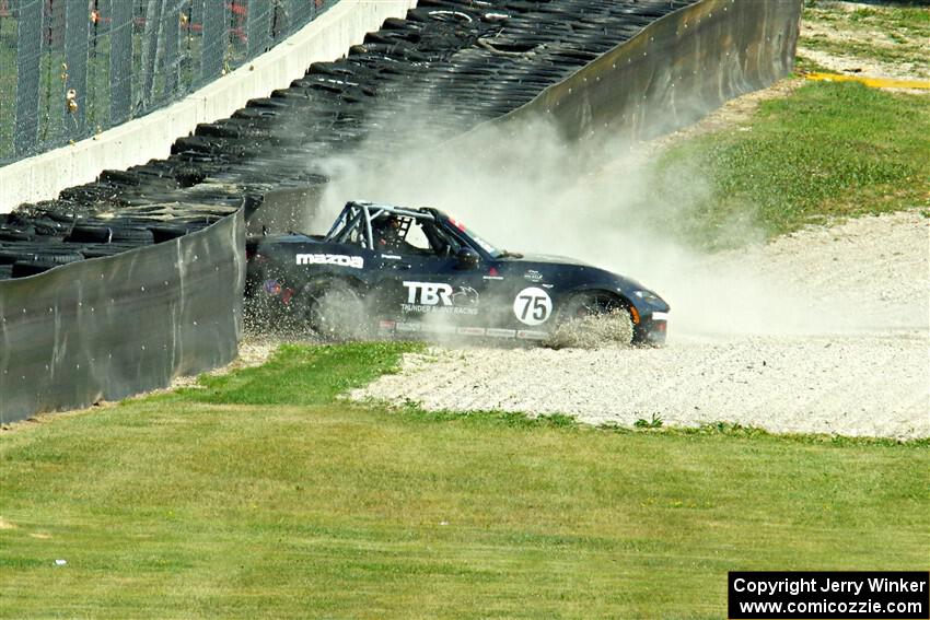 Parker Kligerman's Mazda MX-5 Cup backs it into the tires at turn 6.