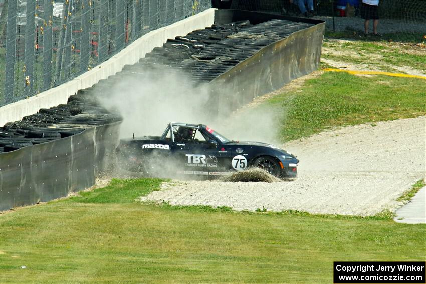 Parker Kligerman's Mazda MX-5 Cup backs it into the tires at turn 6.