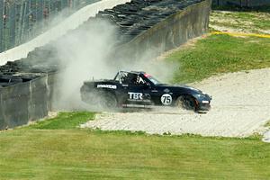 Parker Kligerman's Mazda MX-5 Cup backs it into the tires at turn 6.