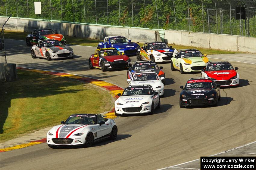 The MX-5 Cup field heads through Canada Corner on the pace lap.