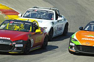 Jared Thomas and Matthew Dirks pass Gresham Wagner, all in Mazda MX-5 Cups.