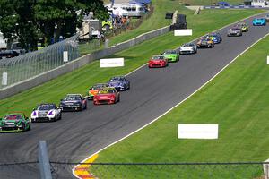 The field streams down the Hurry Downs into turn 8, on lap 1 of race 2.