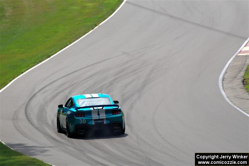 Scott Thomson's Ford Mustang Dark Horse R limps through Thunder Valley on the pace lap of race 2.