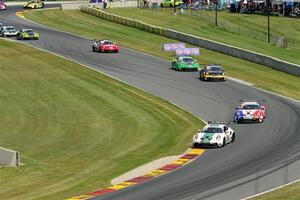 Porsche GT3 Cups stream into the Hurry Downs on lap one of race 1.