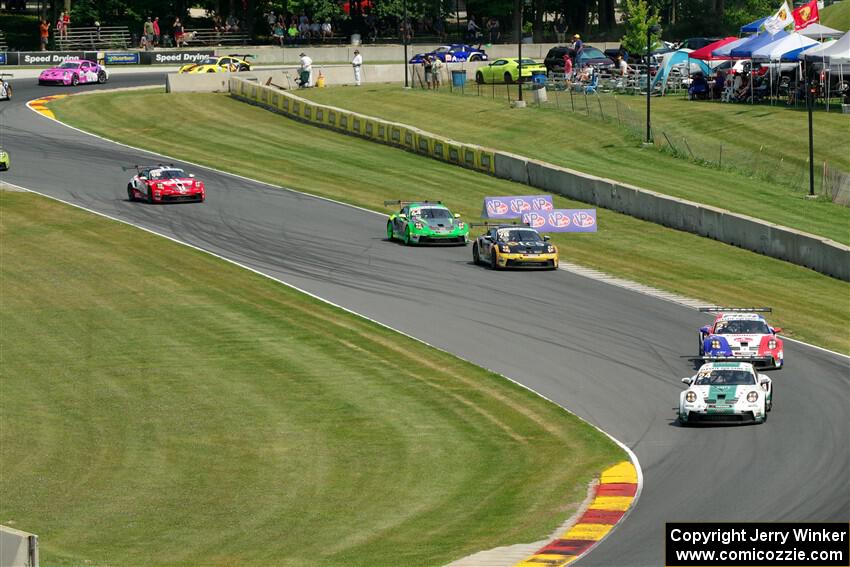 Porsche GT3 Cups stream into the Hurry Downs on lap one of race 1.