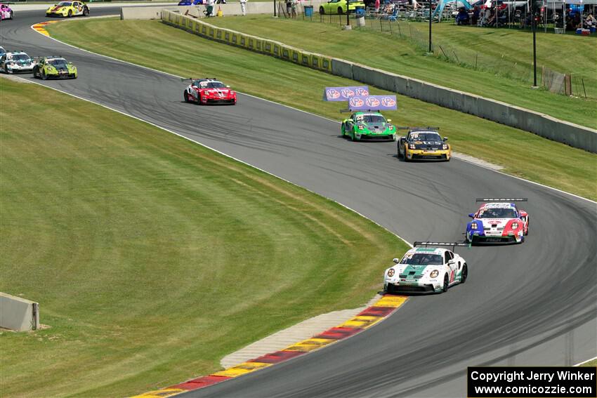 Porsche GT3 Cups stream into the Hurry Downs on lap one of race 1.