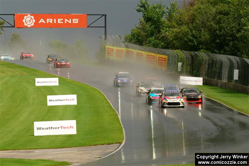 The field streams down into turn 3 on the restart.