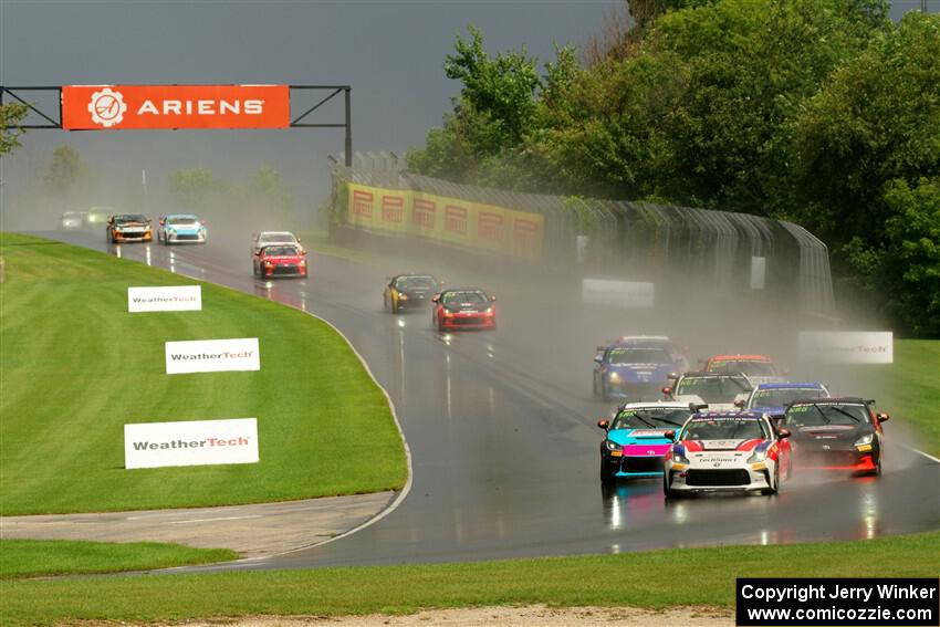 The field streams down into turn 3 on the restart.