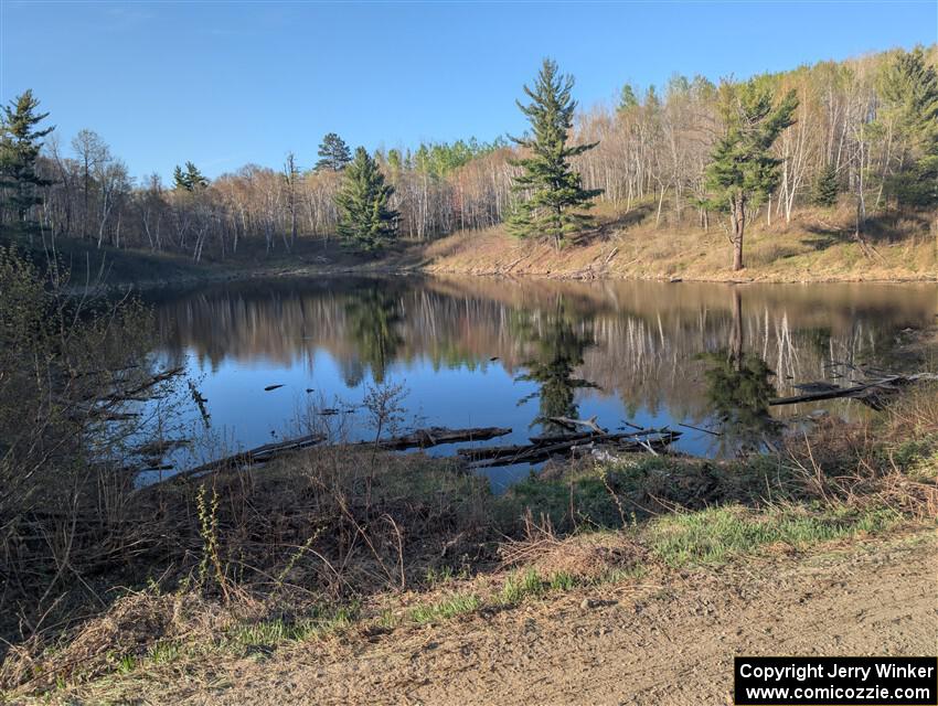 The view of a small lake at the NE corner of the crossroads.
