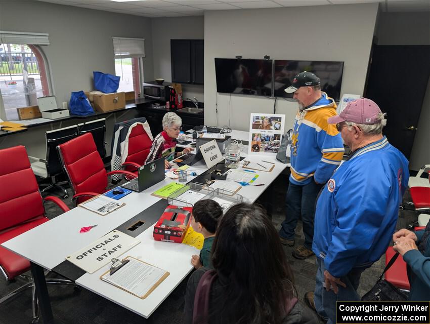 Crews and workers head through registration at the track's front entrance.